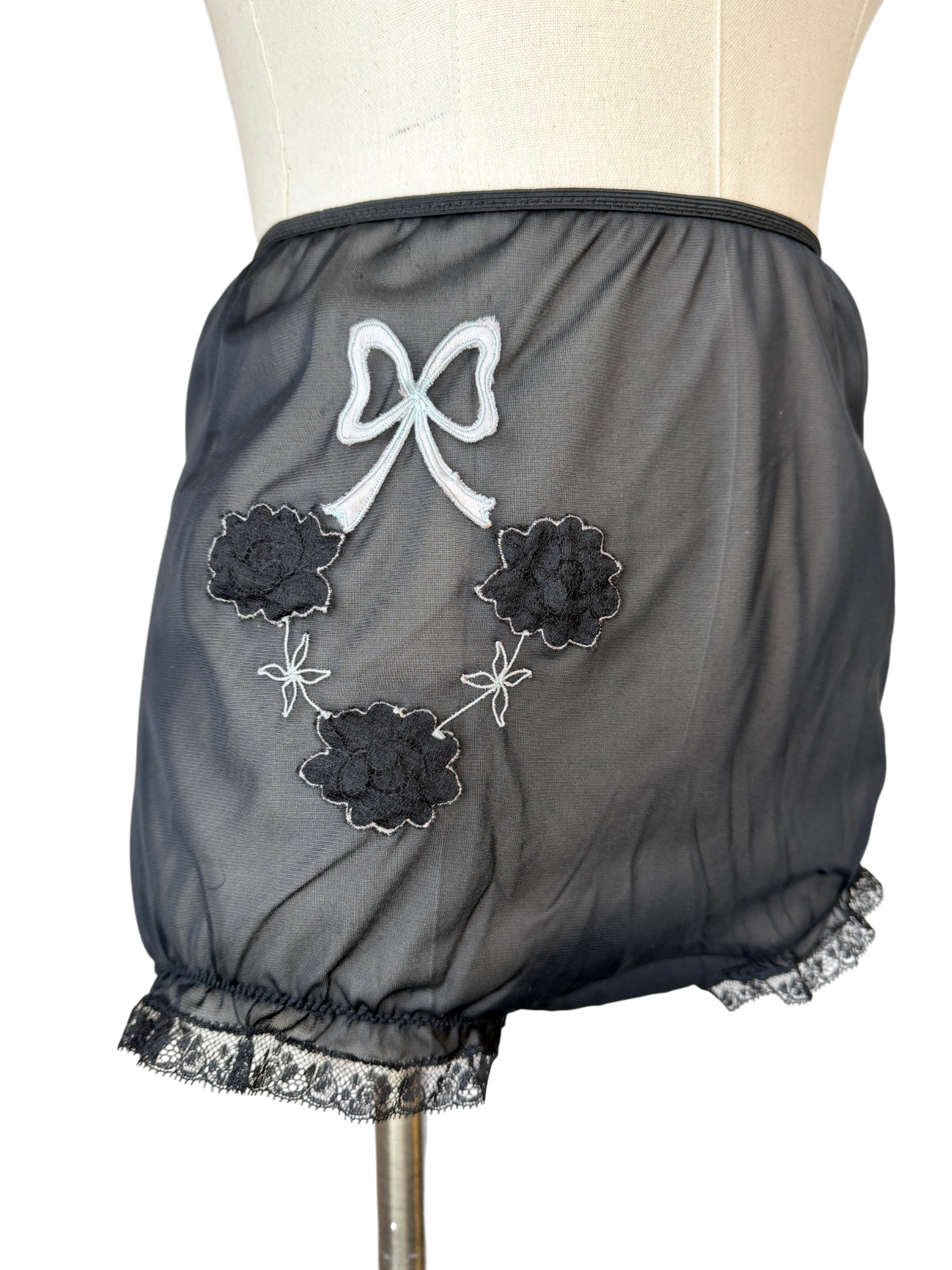 1950s Saks Fifth Avenue black sheer panties with lace ruffle trim and floral & bow appliques